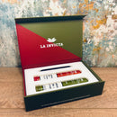 La Invicta cigar packaging with two cigars and cigar cutter inside on a textured surface